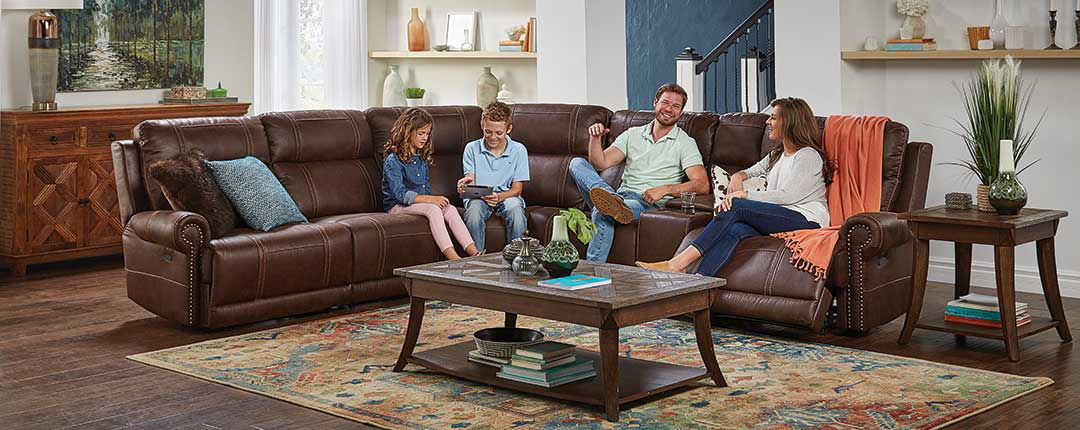 family sitting on sofa